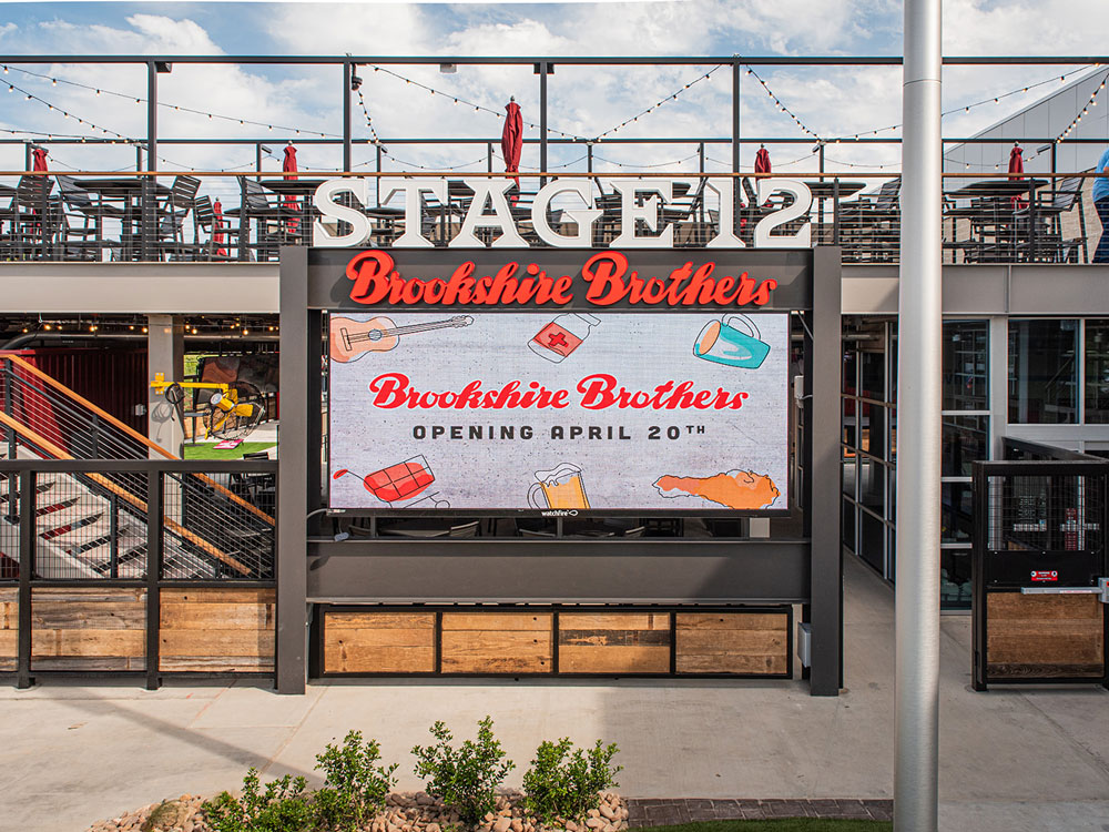 'Stage 12' sign leading up the stairs to outdoor seating on the second floor