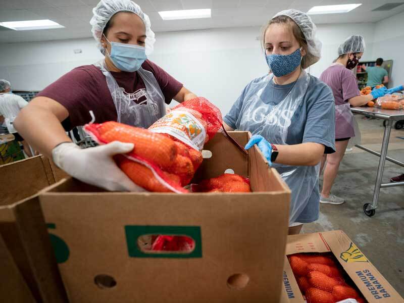 students organizing produce at a food bank