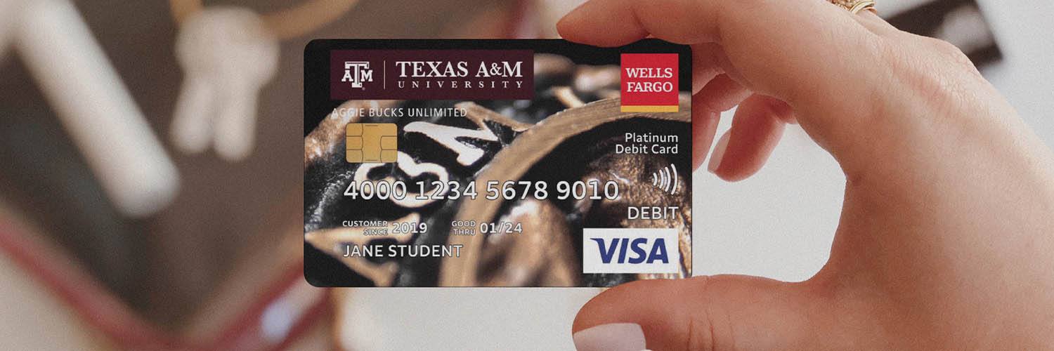 hand holding a Texas A&M branded Wells Fargo debit card