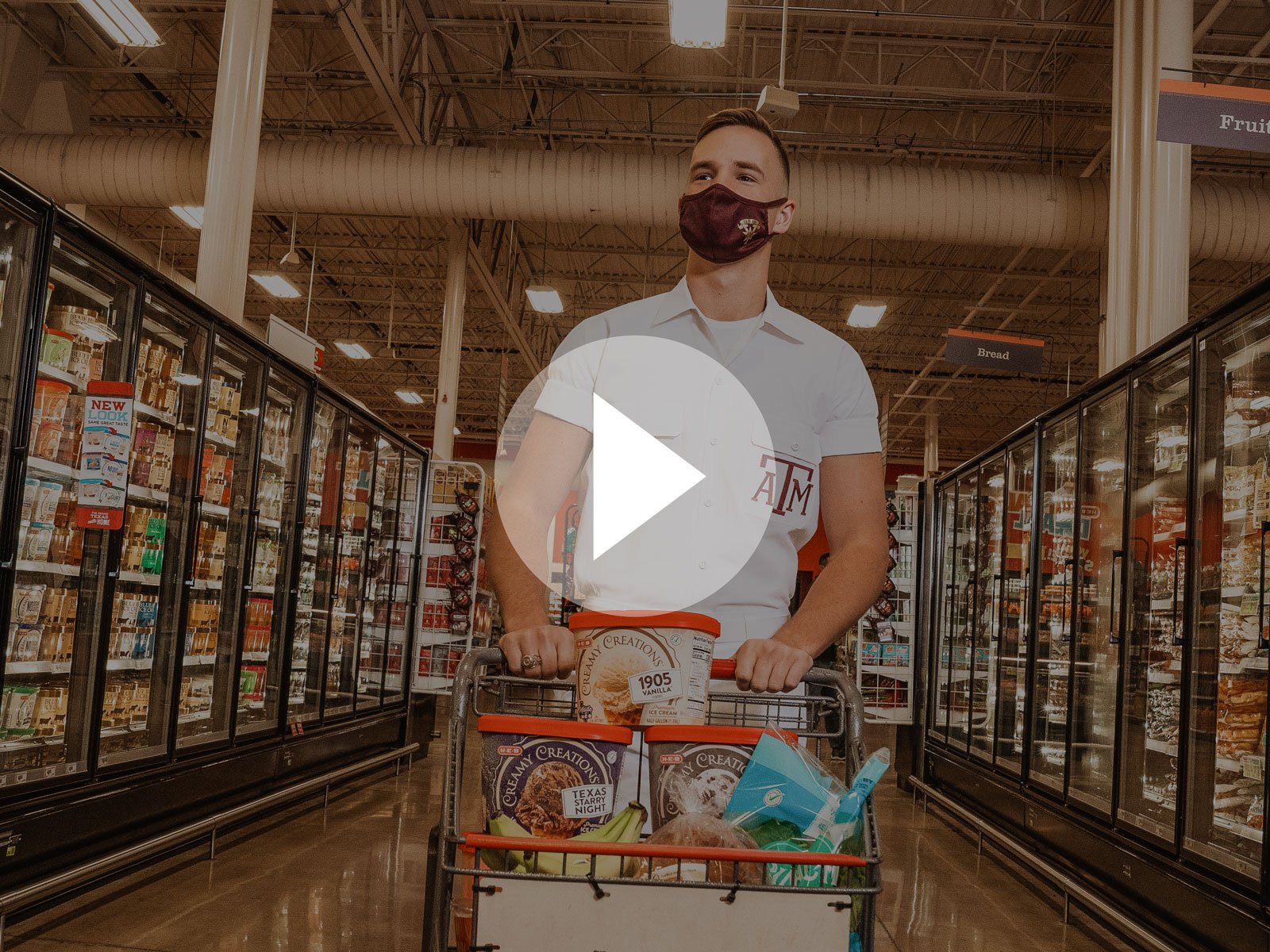 Texas A&M Yell Leader pushing his cart through the frozen aisle at H-E-B